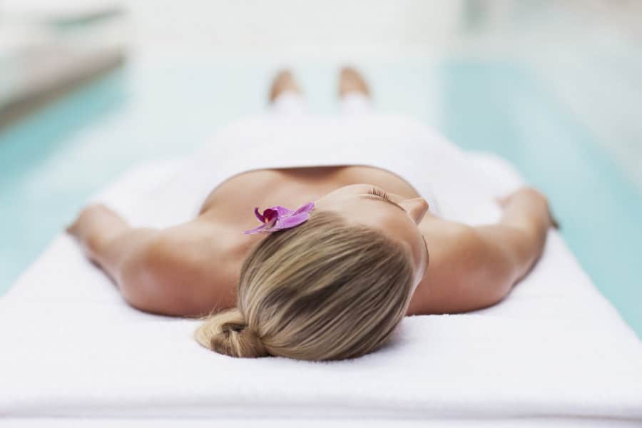 A lady lying on a SPA table in a wellness hotel, which you can book on this website - Hotel Booking India.